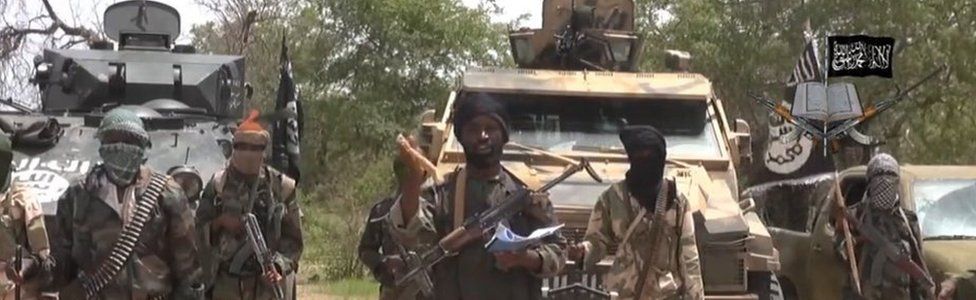 A screengrab taken on 13 July 2014 from a video released by Boko Haram and obtained by AFP shows the leader Abubakar Shekau (C)