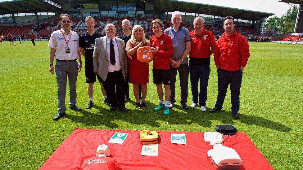 Harry Wilson and members of the FAW with a defibrillator