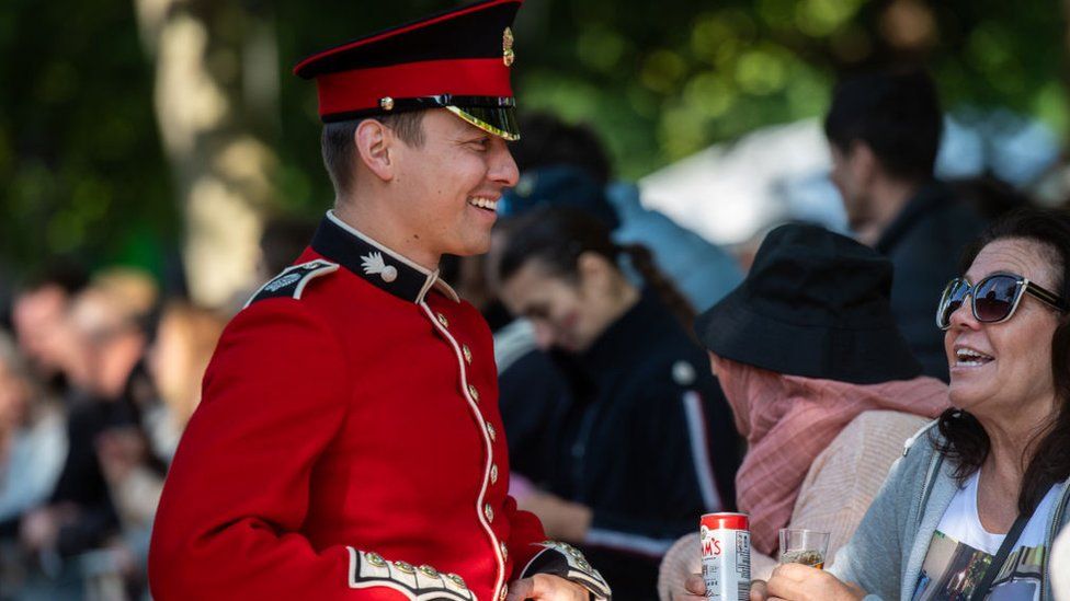 A soldier walking among the crowd before the Trooping of the Colour