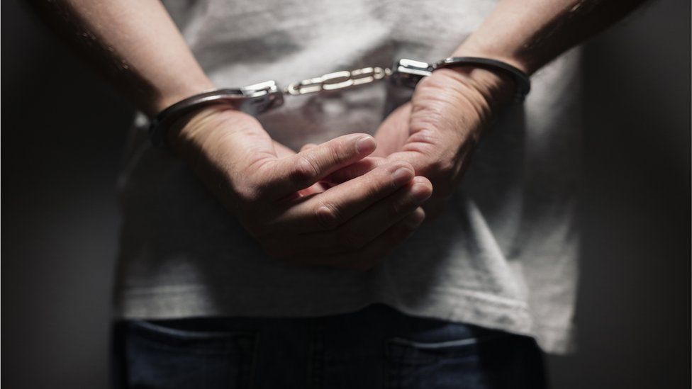 Prisoner in hand-cuffs