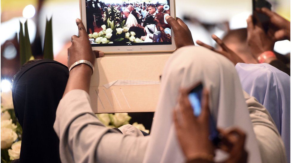 A nun records the arrival of Pope Francis on a tablet at the St. Mary"s school, to attend a meeting of clergy and religious leaders in Nairobi, Kenya, on 26 November 2015.