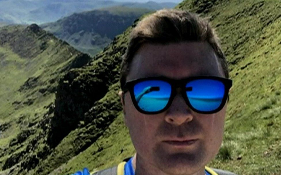 Stephen Hocking takes a selfie on a mountain