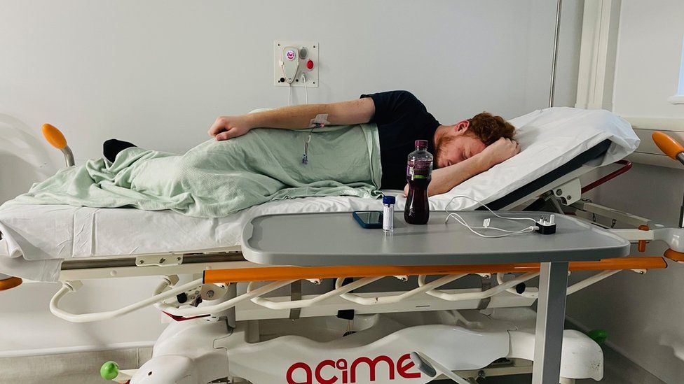Cameron Stone lying in a hospital bed