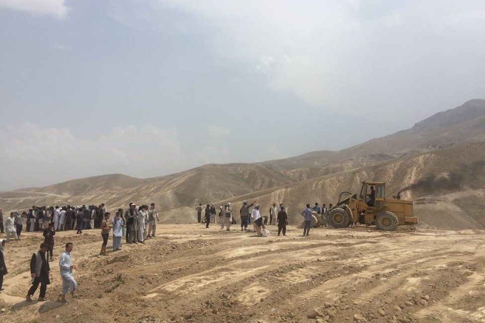 Preparation for digging graves on a hilltop in the west of Kabul, 24 July