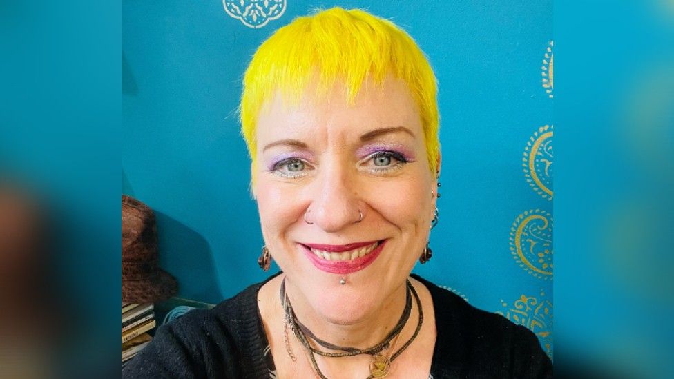 Picture of lady with yellow hair and blue background