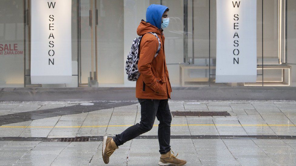 A man wearing a face mask walks in Cardiff, Wales