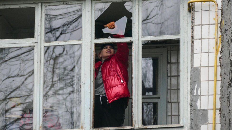 A woman removes debris after a Russian drone stroke on the southern Ukrainian city of Odesa on Monday