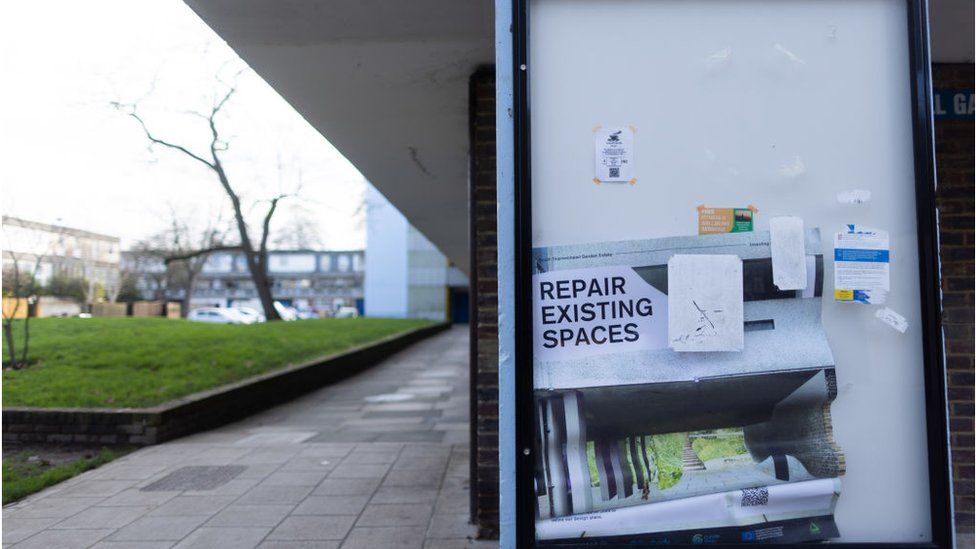 A sign to repair existing spaces is displayed on a housing estate in the Thamesmead district of London