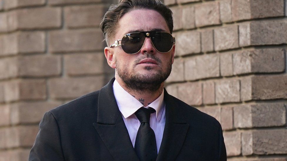 Stephen Bear in a black suit and tie, wearing aviator sunglasses as he arrives at Chelmsford Crown Court.