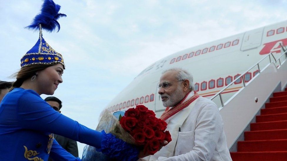 Indian Prime Minister Narendra Modi takes part in a welcoming ceremony at an airport in Astana on July 7, 2015