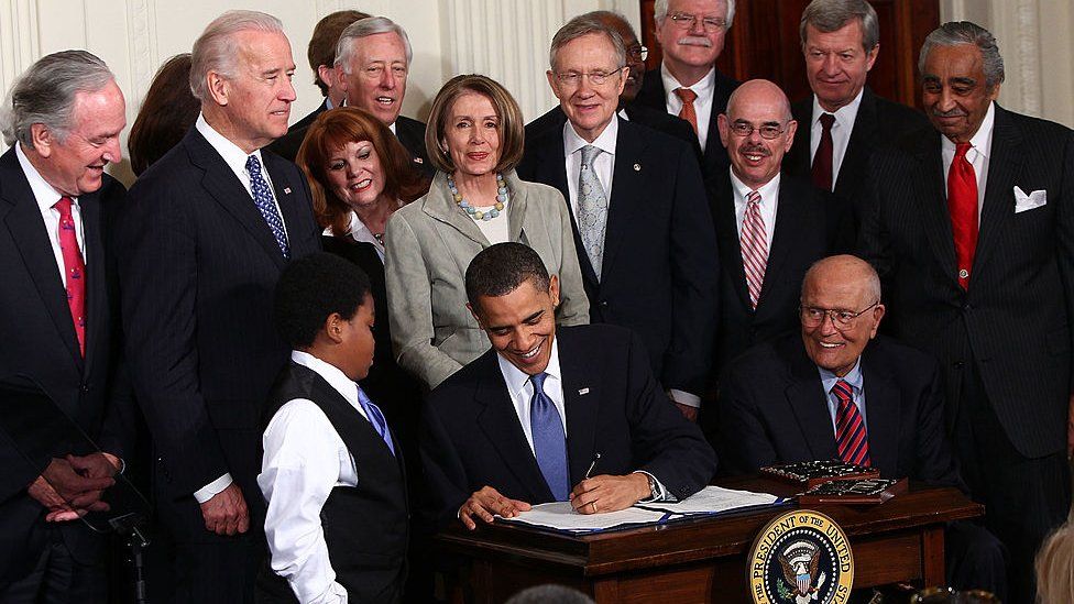 U.S. President Barack Obama signs the Affordable Health Care for America Act during a ceremony with fellow Democrats in the East Room of the White House March 23, 2010 in Washington, DC.