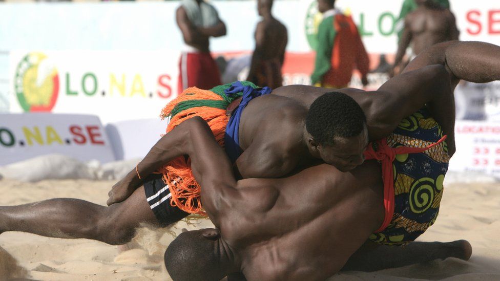 Two people wrestling at a tournament in Senegal - 2009