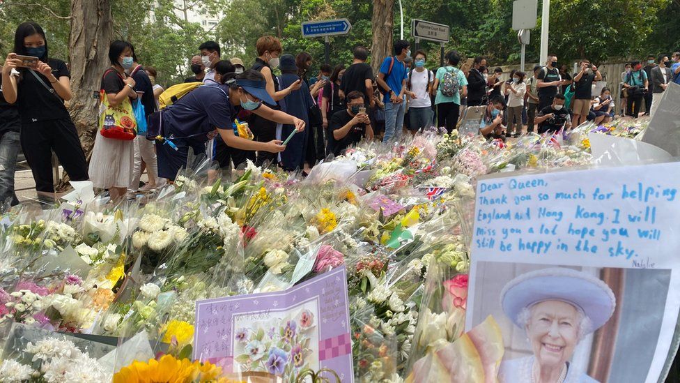 Hong Kongers lay flowers for the Queen outside the UK Consulate