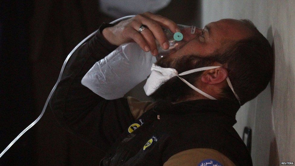 A civil defence member breathes through an oxygen mask, after a suspected gas attack in the town of Khan Sheikhoun in rebel-held Idlib, Syria