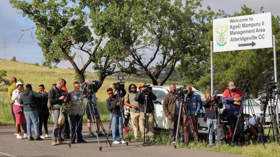 Members of the media set up outside the Atteridgeville Correctional Centre, where South African athlete Oscar Pistorius, convicted of killing his girlfriend Reeva Steenkamp in 2013, is due to be released on parole, in Pretoria, South Africa