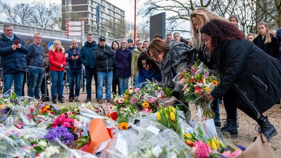 People leave flowers at the site of a shooting on a tram in the Dutch city of Utrecht. 19 March 2019
