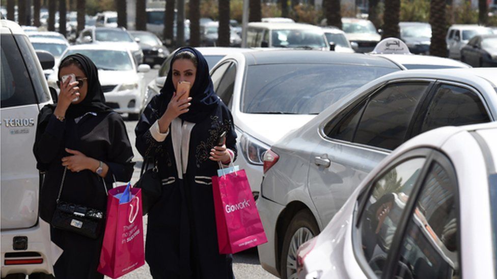 Women walk among traffic in Riyadh (file photo)