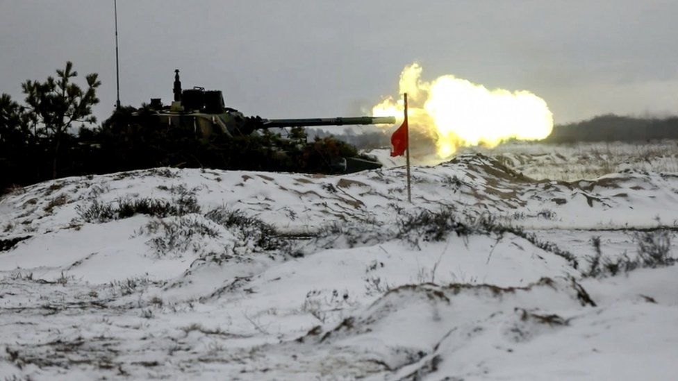 A Russian armoured infantry vehicle shoots from a cannon attending the joint operational exercise of the armed forces of Belarus and Russia "Union Courage-2022" at a firing range in Brest region of Belarus on 10 February