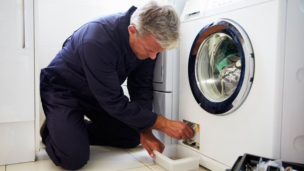 Man repairing washing machine