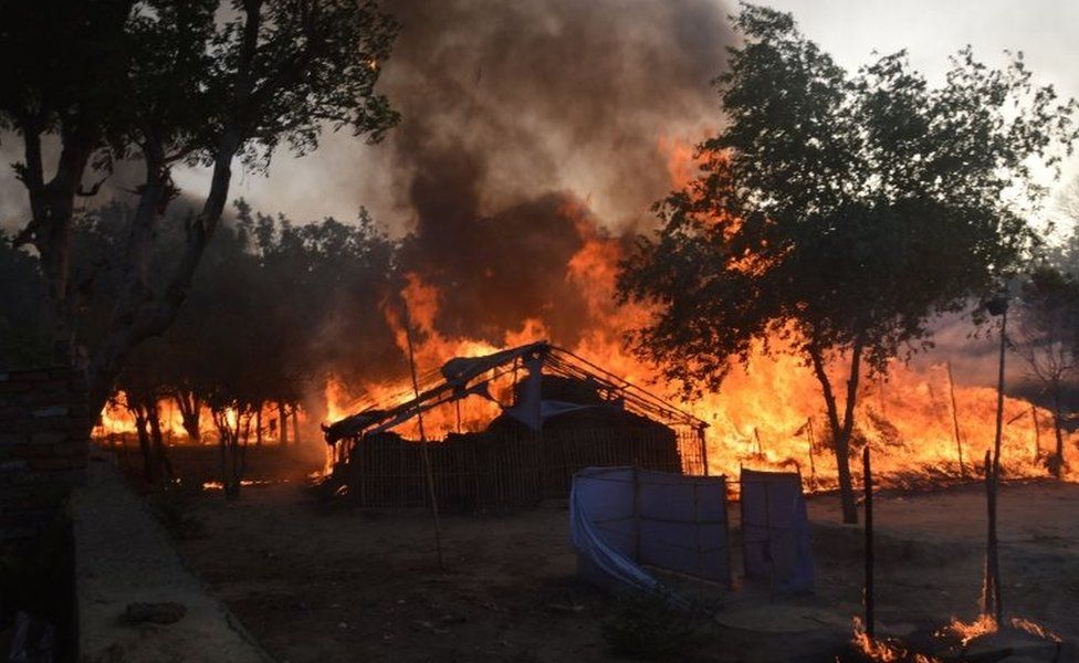 Former homes of Indian members of a sect burn following clashes with police during an eviction at the Jawahar Bagh park in Mathura on June 2, 2016