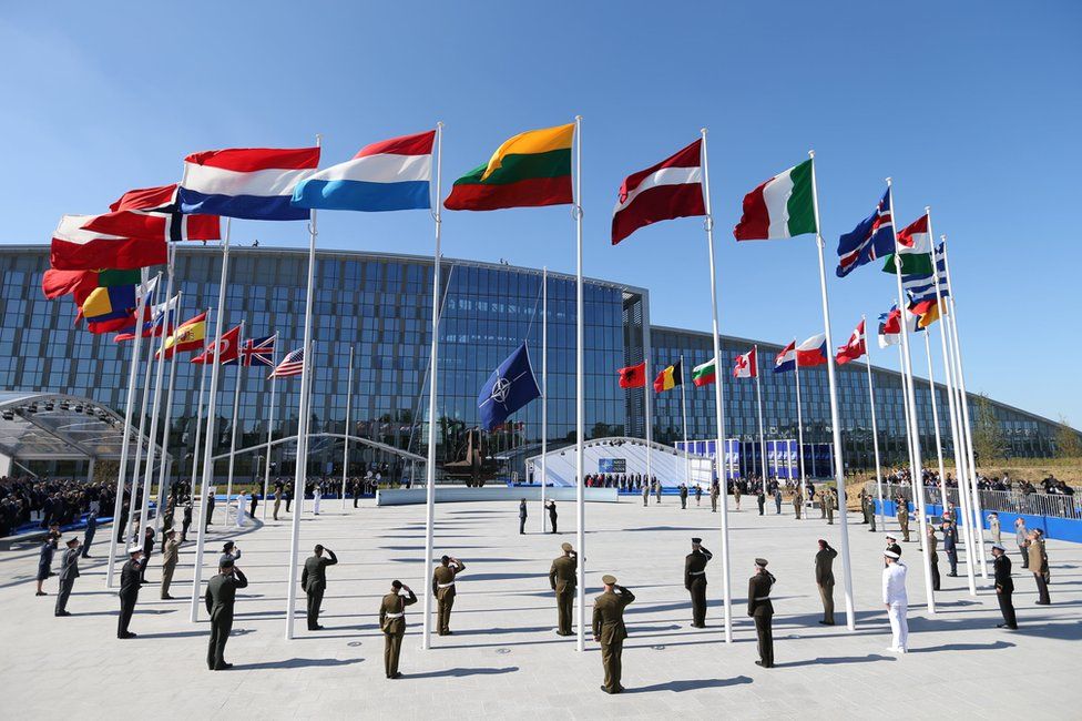 Flags of Nato member countries fly during a ceremony at the new headquarters in Brussels, 25 May
