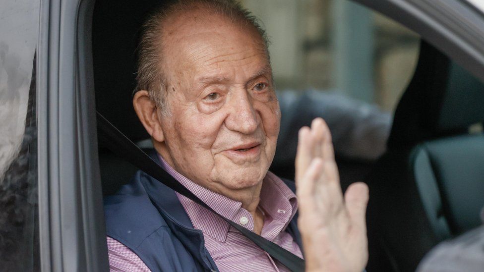 Spain's former King Juan Carlos waves to journalists in Sanxenxo, Spain, 2 October 2023.