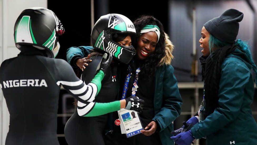 Seun Adigun and Akuoma Omeoga of Nigeria react with Aminat Odunbaku in the finish area during the Women's Bobsleigh heats on day twelve of the PyeongChang 2018 Winter Olympic Games at the Olympic Sliding Centre on February 21, 2018 in Pyeongchang-gun, South Korea.