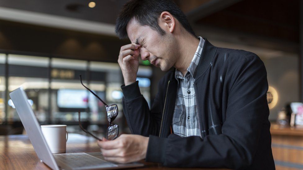 Stressed man working with laptop