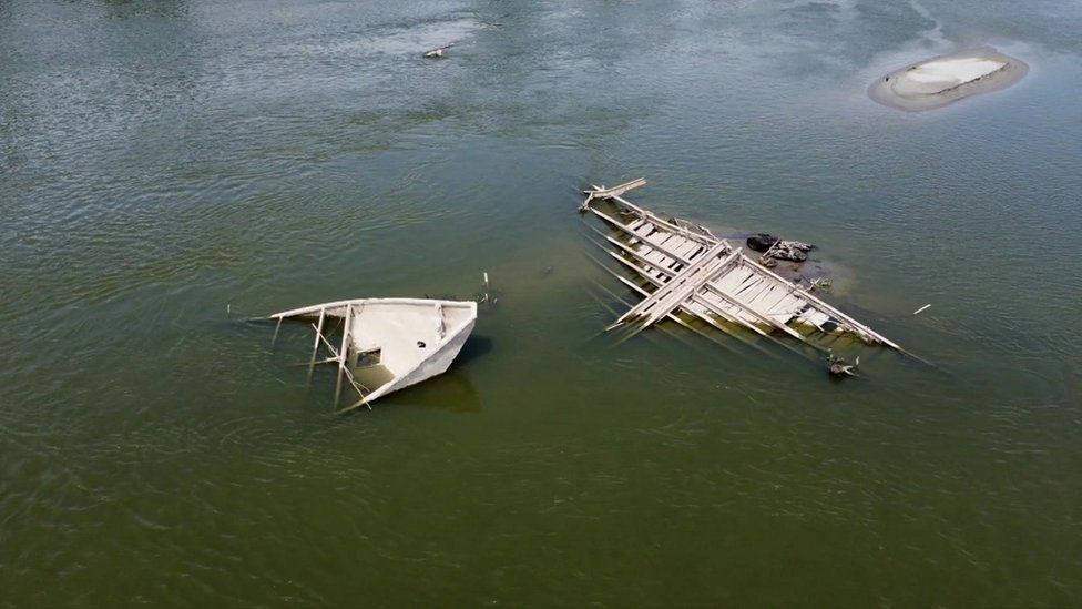The low water levels at the Po river have revealed a sunken World War Two barge and a German military vehicle