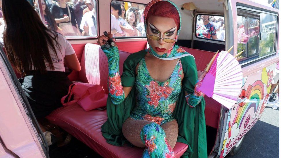 A participant sits in a vehicle during the annual Cape Town Pride celebrations in Green Point, South Africa, March 2, 2024