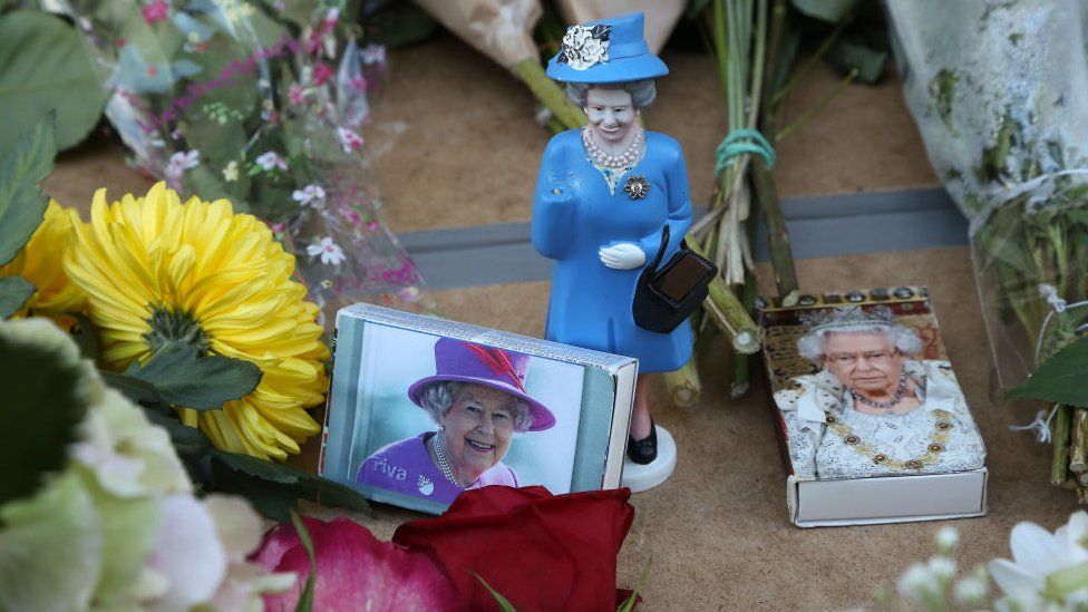 A doll of the queen and matchboxes carrying her picture