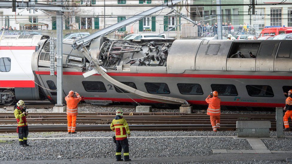 Police and rail workers arrive at the scene of a derailed train in the station of Lucerne, Switzerland, 22 March 2017