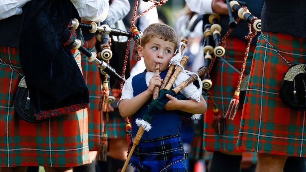 Young boy plays his bagpipes