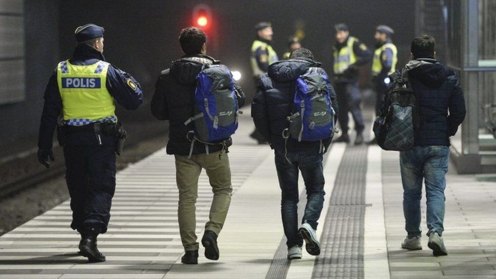 Swedish police escorting asylum seekers