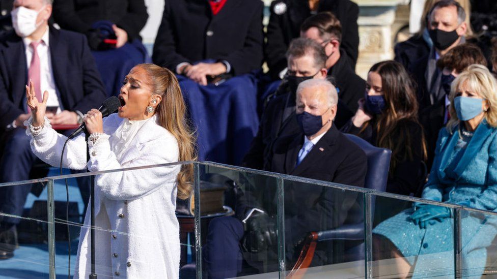 Jennifer Lopez performing at the inauguration with Joe Biden sitting behind her