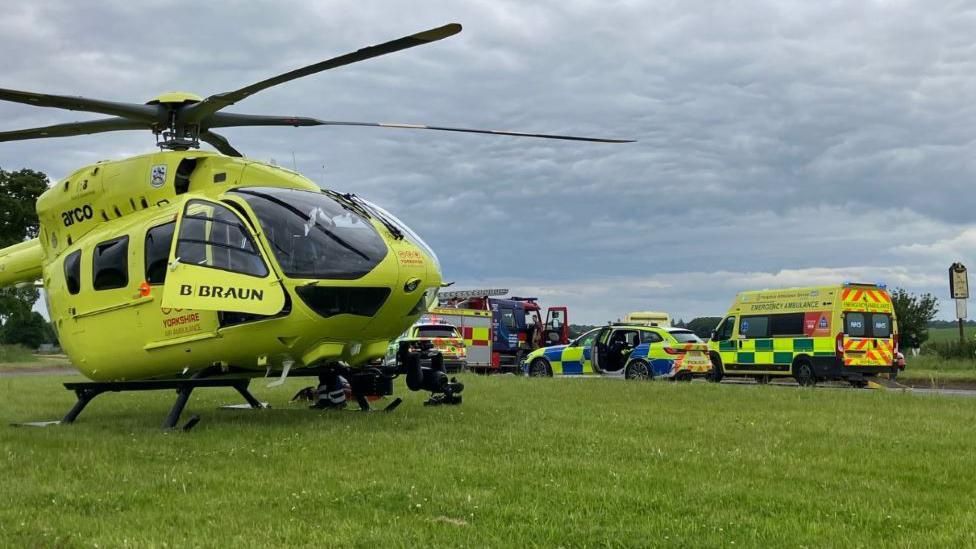 Air ambulance, fire and police crews at the scene of the crash on the A19
