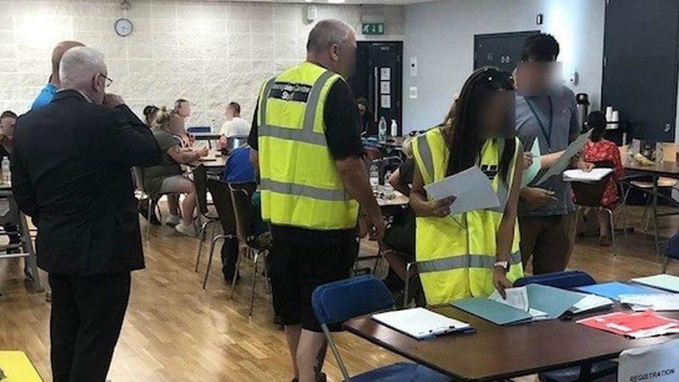 People helping at an emergency centre at The Venue Leisure Centre, Hertfordshire