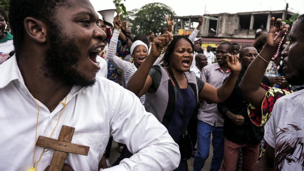 Catholics sing and dance during a December 31, 2017 demonstration to call for the President of the Democratic Republic of the Congo to step down.