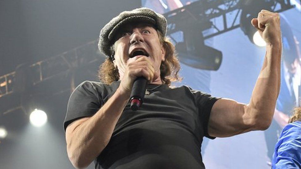 In this 17 February 2016 file photo, Brian Johnson, left, and Angus Young perform with AC/DC on the Rock or Bust Tour in Chicago.
