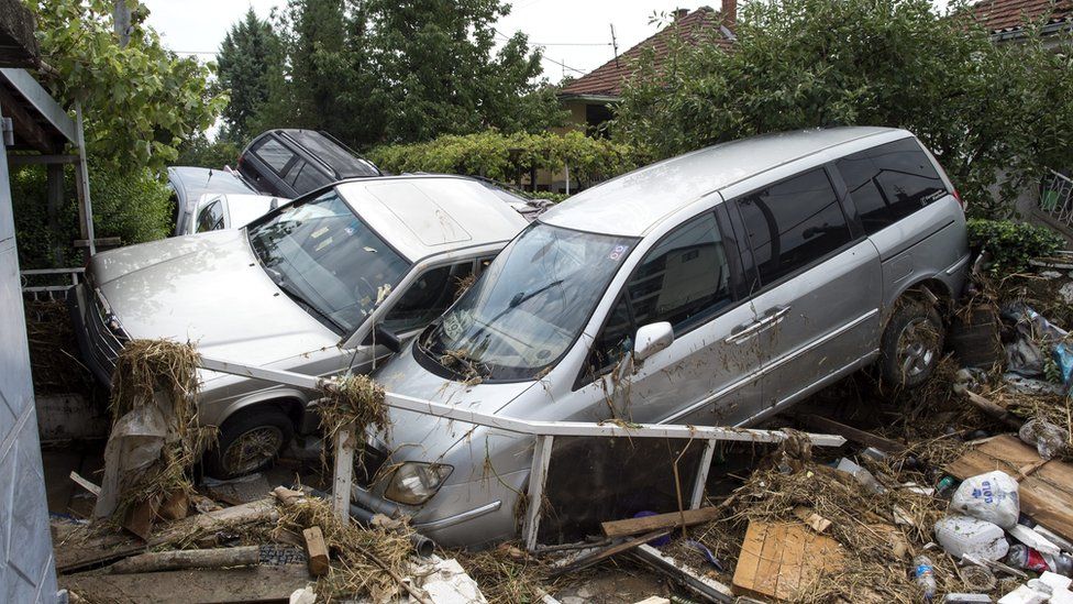 a pile of cars that has crashed together between some houses, 7 August 2016