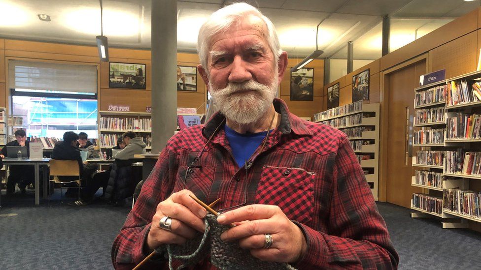 Henry Gowman holding knitting needles