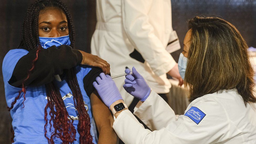 A young woman is vaccinated