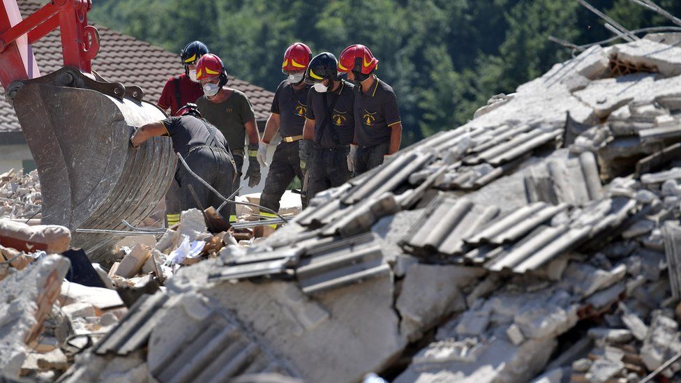 Rescue workers at the scene in Amatrice, Italy