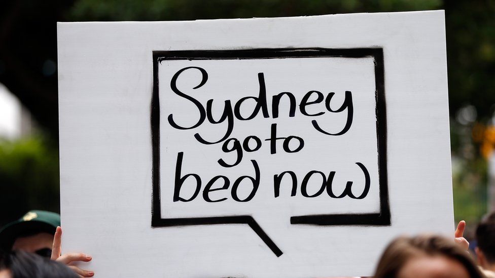 A protester holds up a sign at Keep Sydney Open protests
