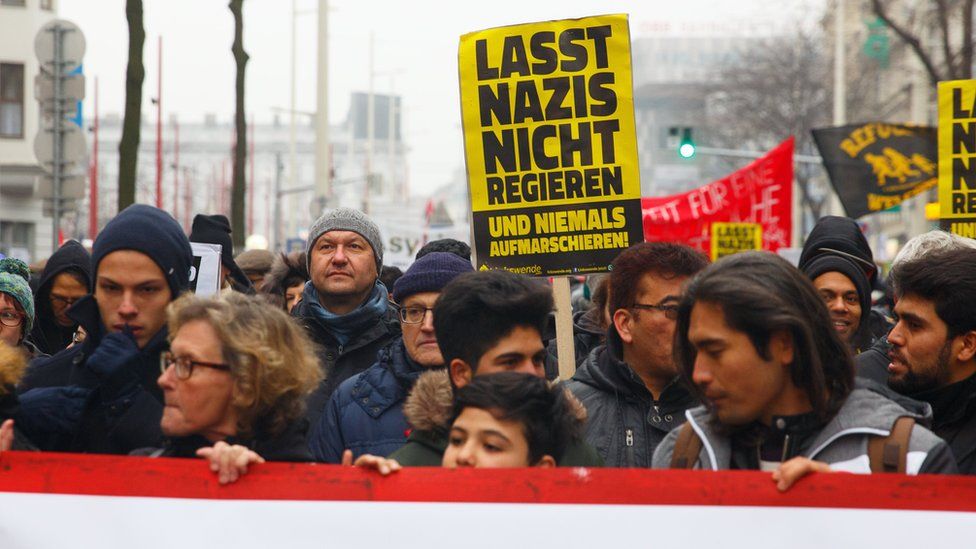 Protesters carry posters reading "don't let Nazis govern" in Vienna, Austria, 13 January 2018.