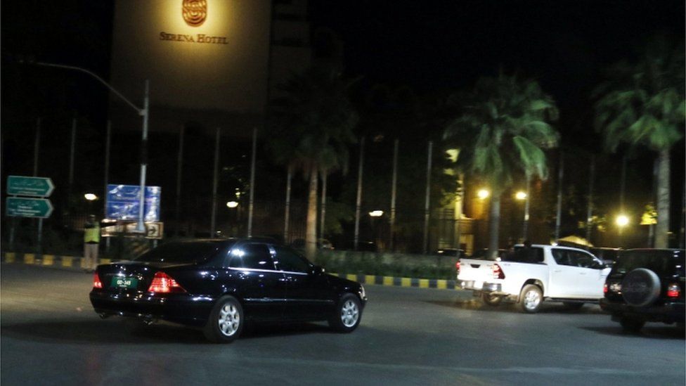 A car is photographed arriving at a hotel in Islamabad