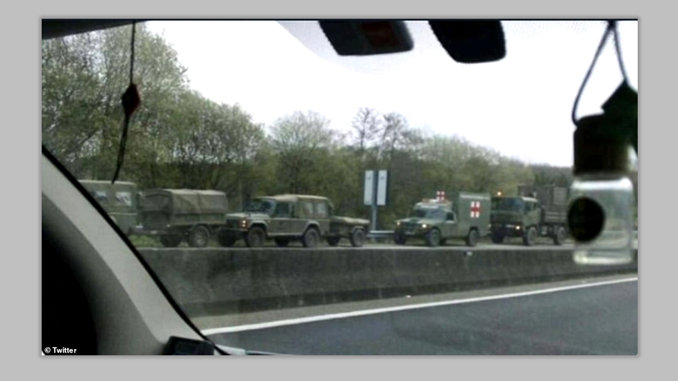 Military vehicles on the side of the road