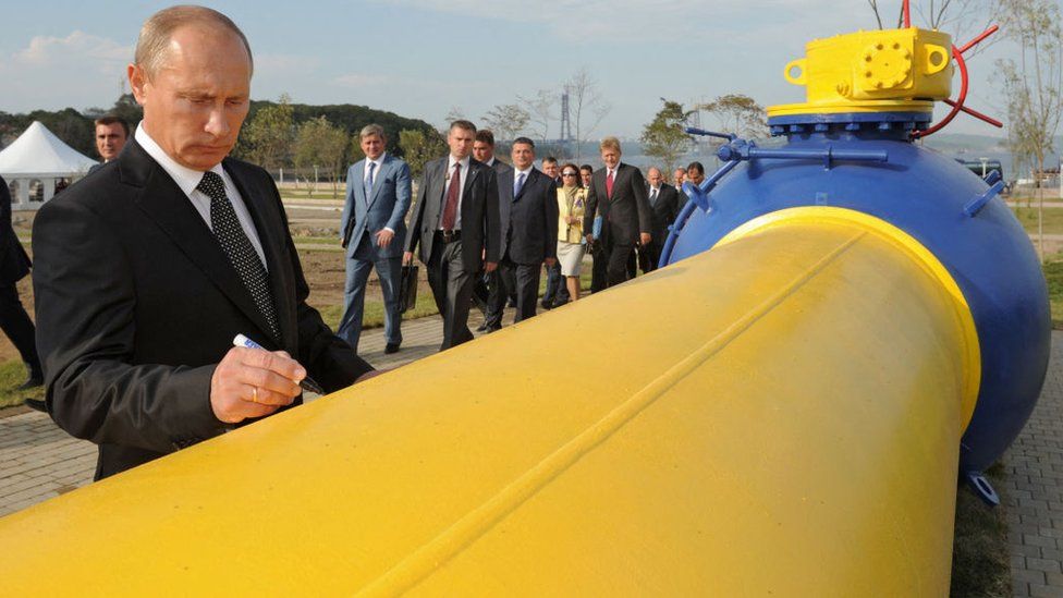 Russian President Vladimir Putin signs an oil pipeline