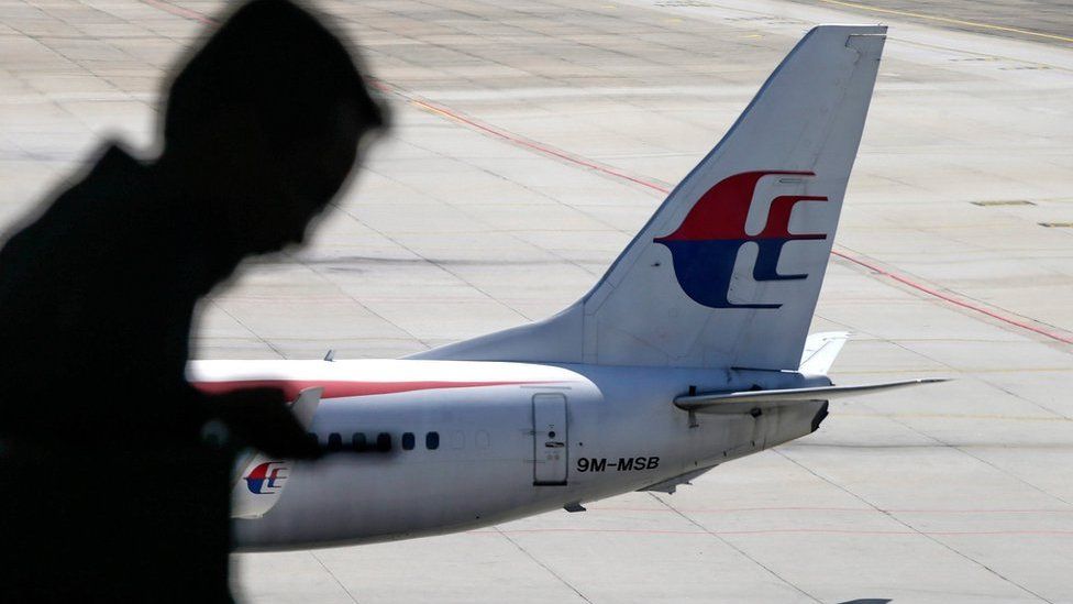 A file picture dated 17 July 2016 shows a passenger walking past a Malaysia Airlines aircraft within a viewing gallery of the Kuala Lumpur International Airport (KLIA) in Sepang, outside Kuala Lumpur, Malaysia.
