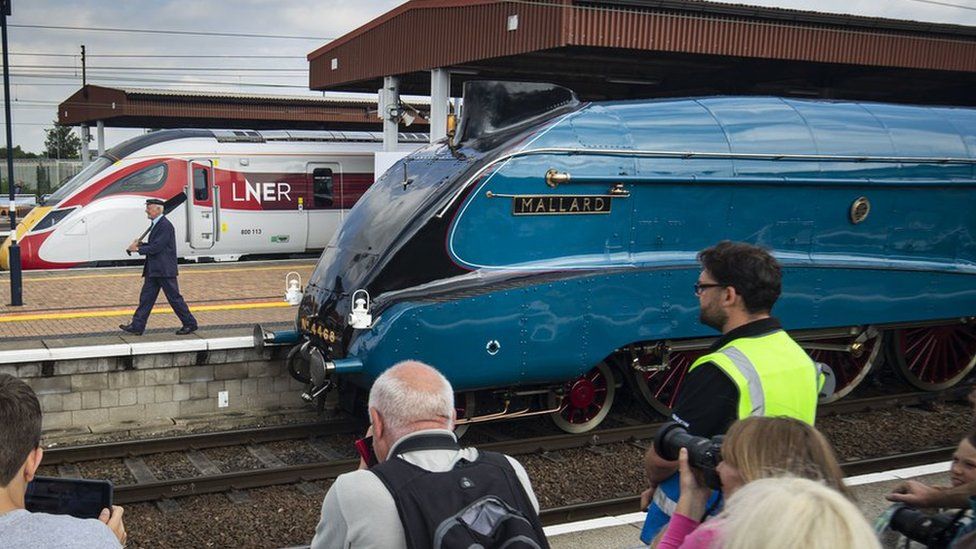 Mallard steam locomotive being photographed by people